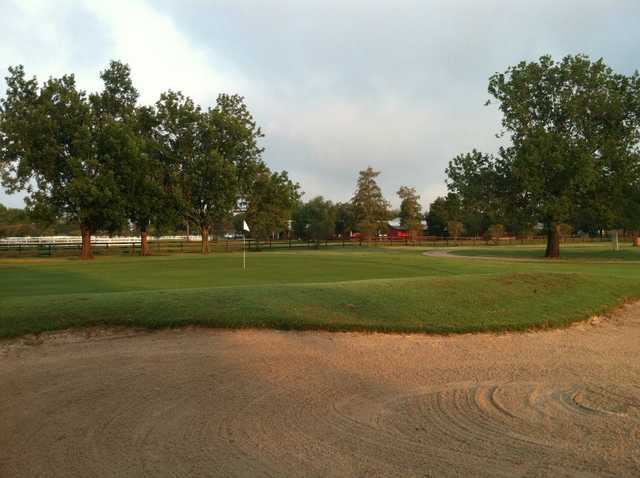 A view of a hole protected by a large tricky bunker at Bayou Oaks City Park North Course