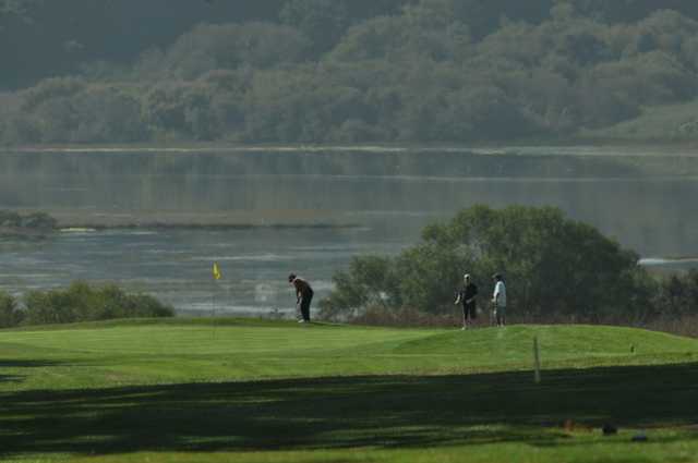 A view of a green with water in background at Pajaro Valley Golf Club