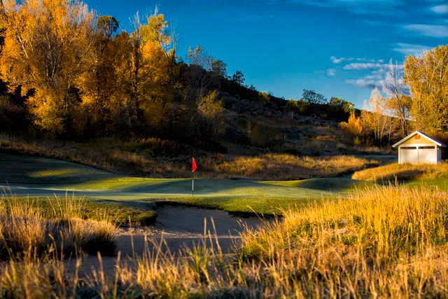 A view of a green protected by bunkers at Eagle Ranch Golf Club