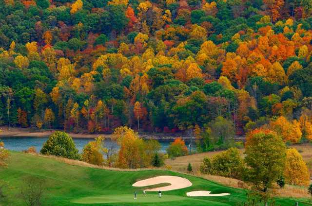 A splendid view of a green protected by bunkers from The Arnold Palmer Signature Course At Stonewall Resort