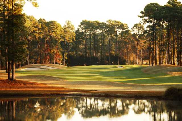 A sunny day view of a hole at Hilton Head National Golf Club