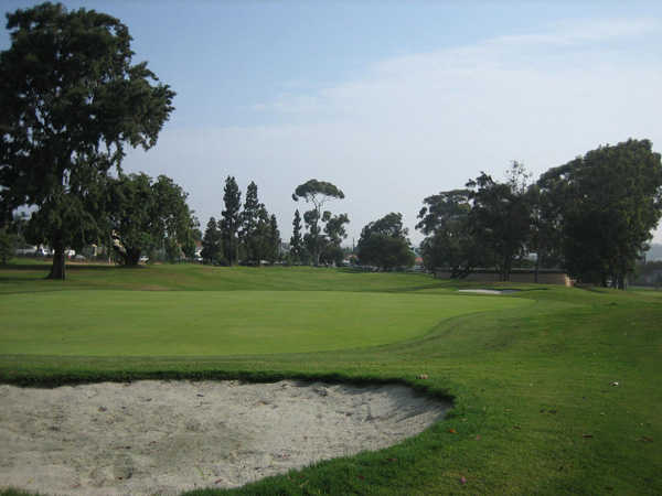 A view of green with bunker in foreground at  The Loma Club