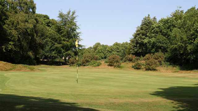 A sunny day view of a hole at Limpsfield Chart Golf Club