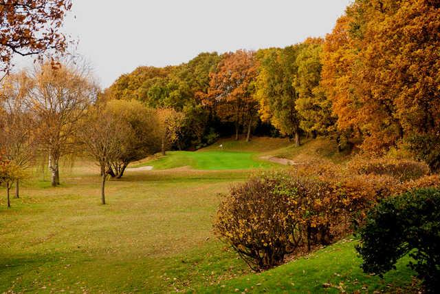 Autumn foliage surrounding hole #15 at Wanstead Golf Club
