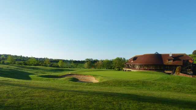 A view of a green and the clubhouse at West Hove Golf Club