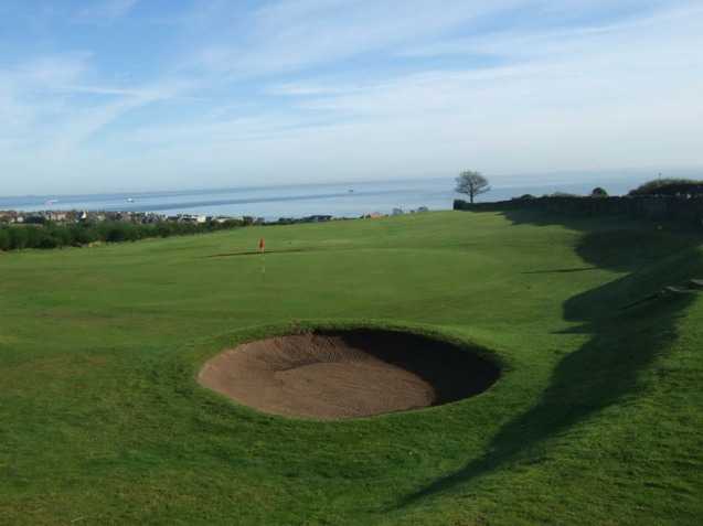 A view of green guarded by bunker at Kinghorn Golf Club