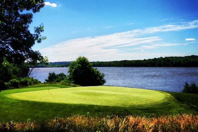 A view of a green with water in background at Mississippi Dunes Golf Links