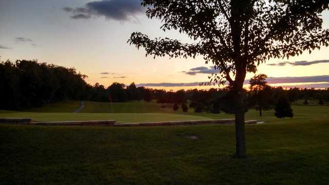 A sunset view of a green at Flatbush Golf Course.