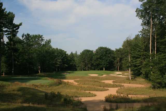 The par-3 fifth hole at Black Lake Golf Club features a waste bunker from tee to green
