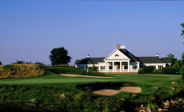 A view of a green protected by tricky bunkers and the clubhouse in background at Raspberry Falls Golf & Hunt Club