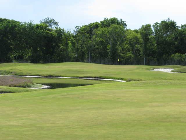 A view of a green protected by a bunker at Rio Colorado Golf Course