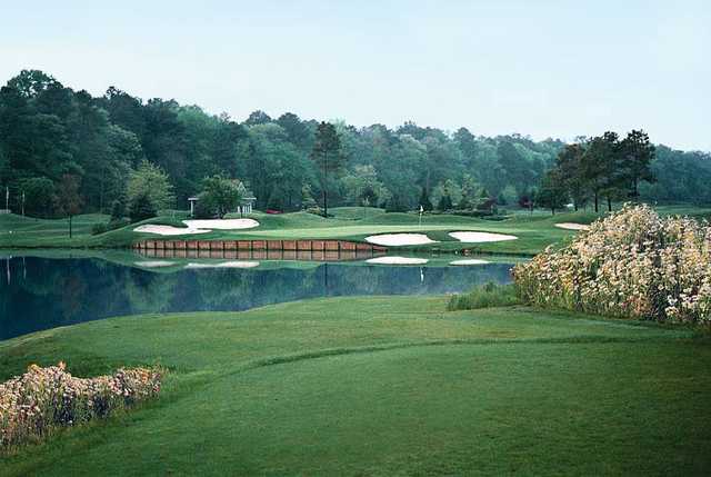 A view of a green with bunkers and water coming into play at River Run Golf Course