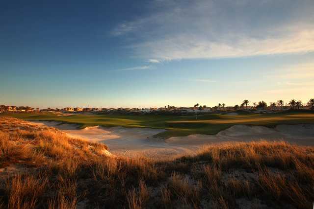 A view of a green with bunkers coming into play at Saadiyat Beach Golf Club