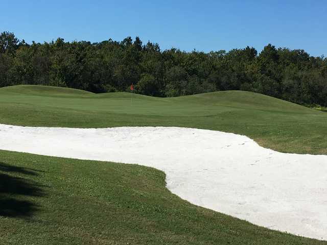 A view of a hole guarded by an undulating bunker at Huntington Hills Golf & Country Club