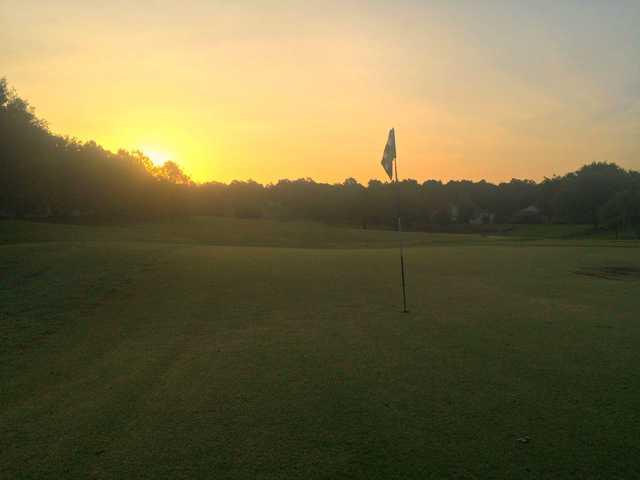A sunset view of a hole at Kings Ridge Golf Club