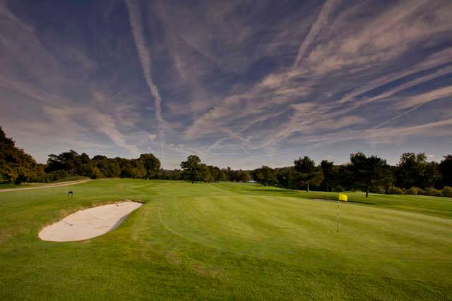 A view of a green protected by a bunker at Hever Castle Golf Club