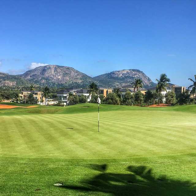 A view of a hole with mountains in the distance at Prestige Golfshire Golf Club