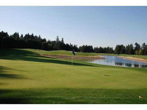 A view of green #16 with water in background at Chehalem Glenn Golf Club