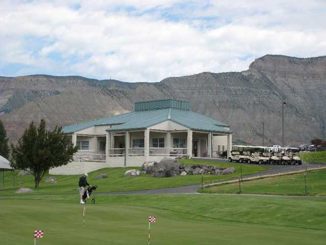 A view of the putting green with clubhouse in background at Battlement Mesa Golf Club