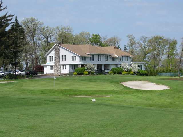 A spring day view of the clubhouse and a hole at Somerset Country Club