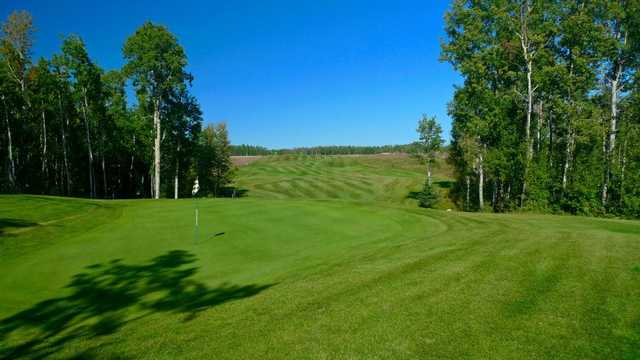 A sunny day view of a green at Dorchester Ranch Golf Course