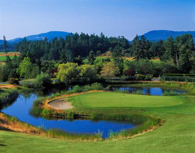 A view of a green surrounded by water at Arbutus Ridge Golf Club