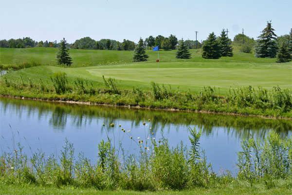 A view over the water of the 16 green at Whispering Ridge Golf Course