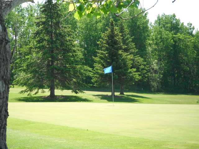 A sunny day view of a green at La Broquerie Golf Course