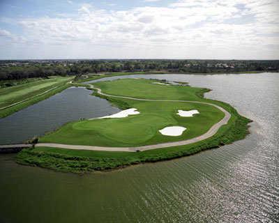Aerial view of green #3 surrounded by water at Legacy Golf Club