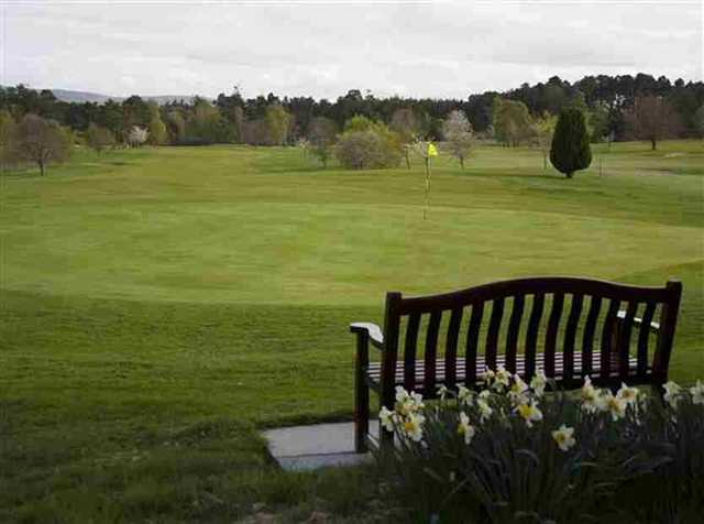 Bench beside the green at Forres GC