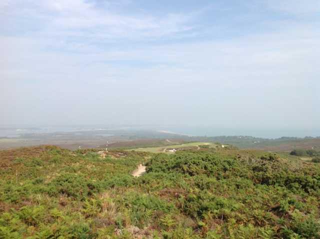 A scenic view of the 3rd hole with the sea in the horizon at  Isle of Purbeck Golf Club