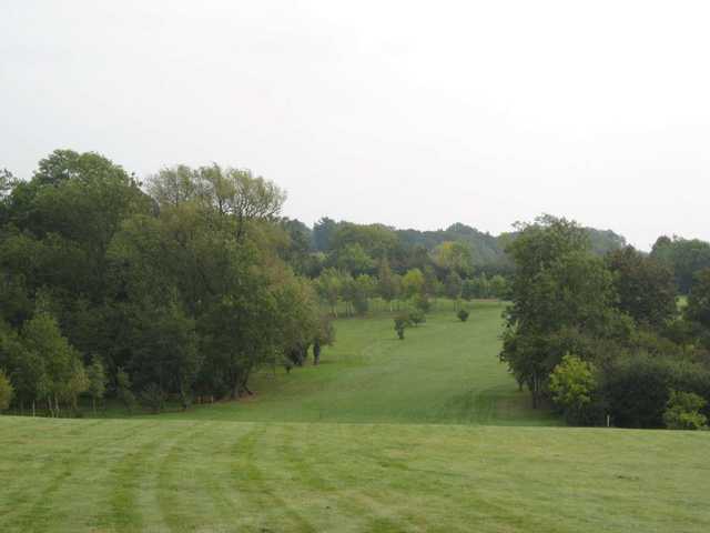 Down hill view of a fairway approaching the green at Gaudet Luce Golf Club