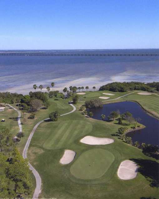 Aerial view of a green protected by bunkers at Cove Cay Golf Club