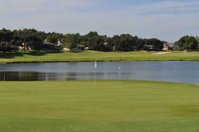 A view of a green with water in background at Green Valley Country Club.