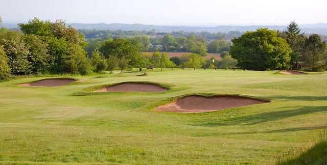 The bunker-guarded 16th green at The Mendip Golf Club