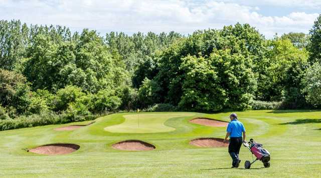 The bunker-guarded 6th green on the Stoneleigh Deer Park Golf Course