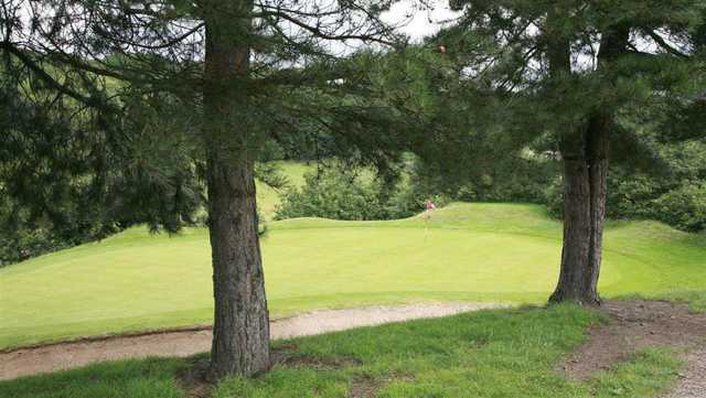 A view of the course through trees at Deane GC 