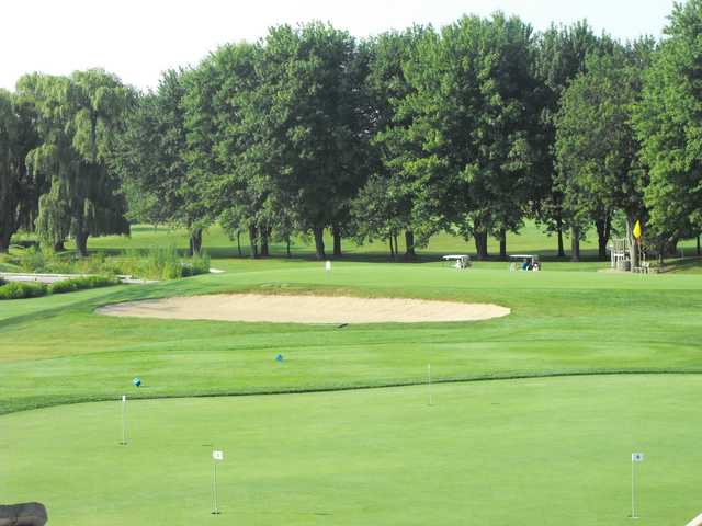 A view of the practice putting green and a hole at Talbot Trail Golf Club