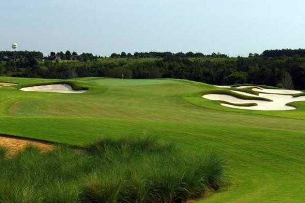 A view of a green protected by bunkers at Bella Collina Golf Club