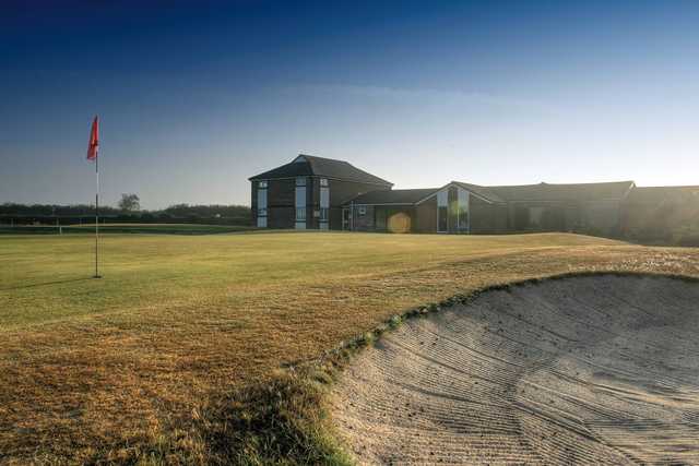 View of a green and clubhouse at Holsworthy Golf Club