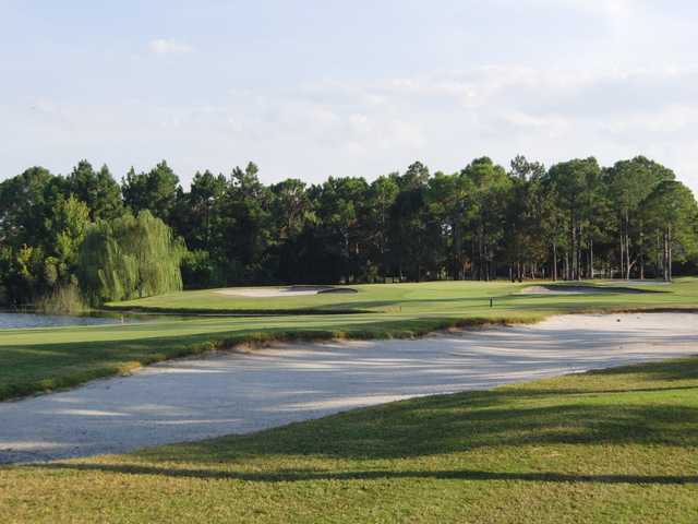 A view of the 11th green with bunkers on sides at Spruce Creek Country Club