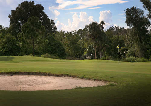 A view of a green with bunker in foreground at Riverside Golf Course