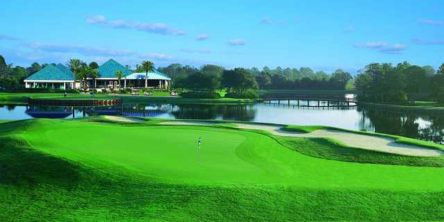 A view of the clubhouse and a green in foreground at University Park Country Club