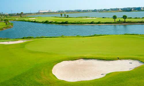 A view of the 14th green with bunker in foreground at Moody Gardens Golf Course