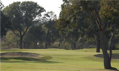 A view of a green protected by bunkers at Grand Oaks Golf Club