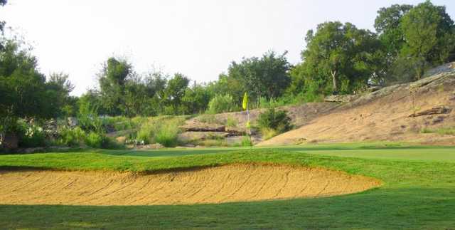 A view of a green with a bunker in foreground at Lighthouse Country Club