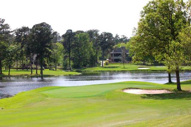 A view of a green surrounded by water at Crown Colony Country Club.