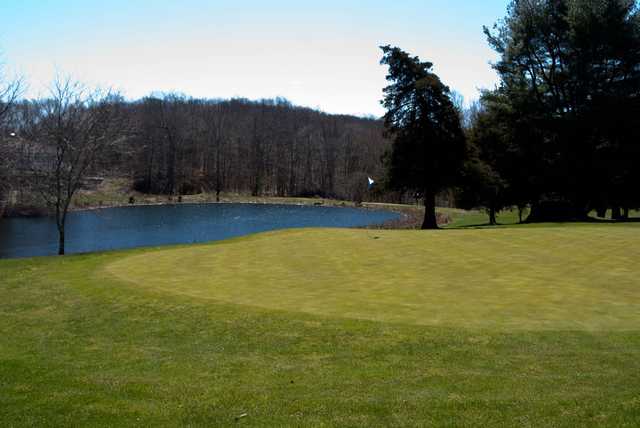 A view of a green with water in background at Cedar Ridge Golf Course.