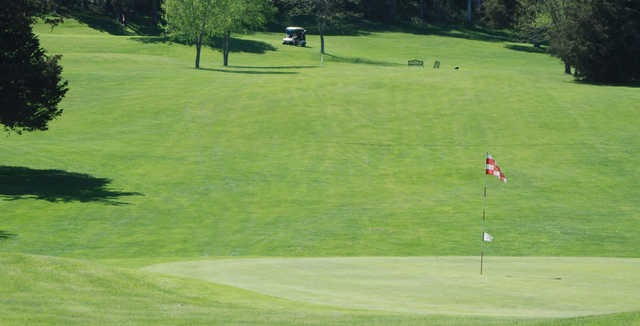 A sunny day view of a hole at Cedar Ridge Golf Course.