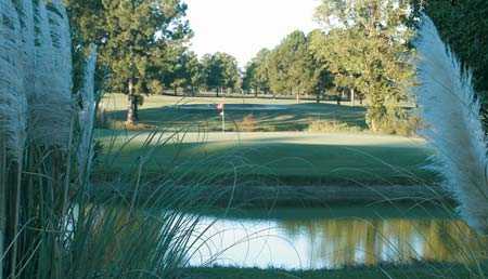 A view of a green surrounded by water at Hillcrest Golf Course
